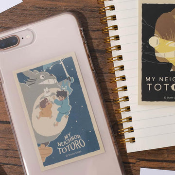 Phone case with 'My Neighbor Totoro' design on a wooden surface